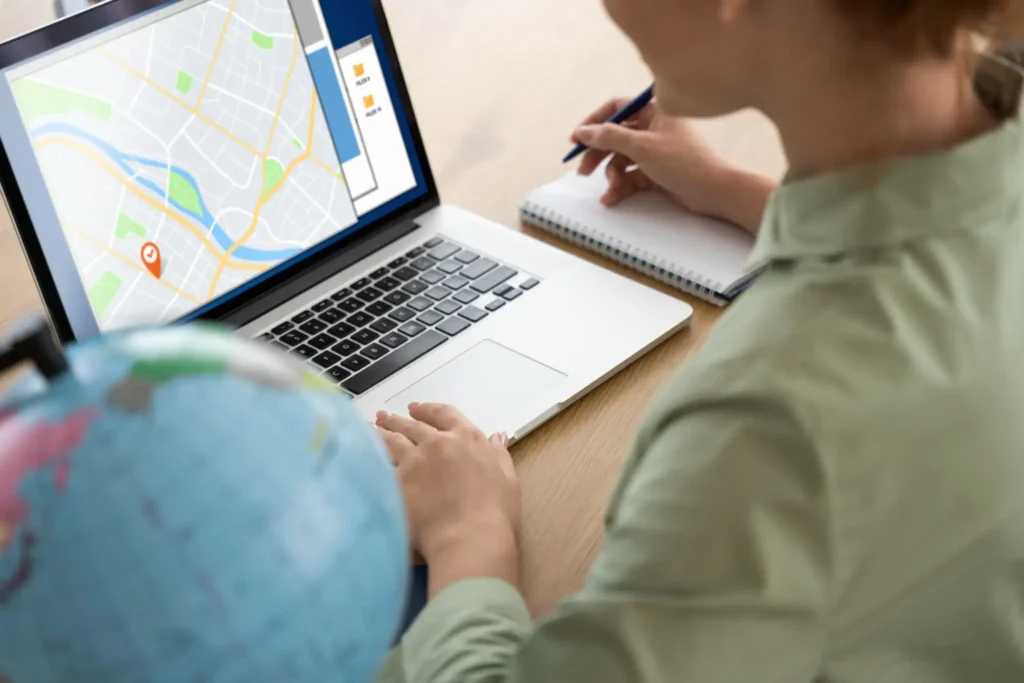 Using Local SEO Strategies to Help Schools Get Found in Their Area Person analyzing local map on laptop for school SEO planning
